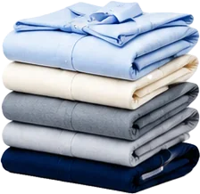 A neat stack of freshly folded and pressed shirts